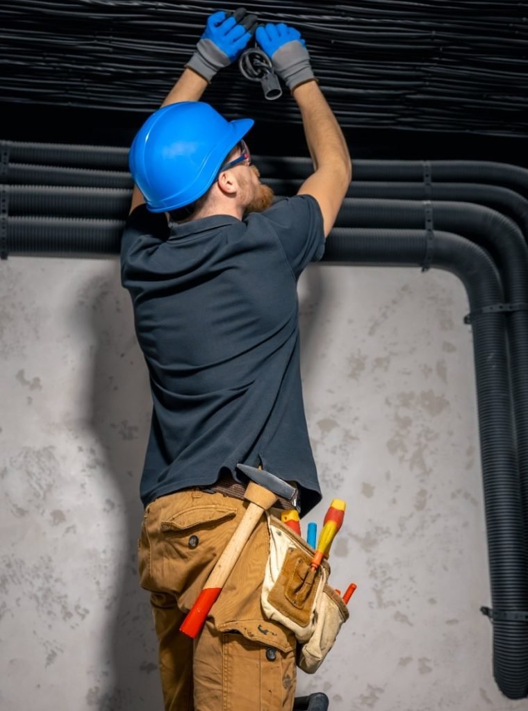 electrician-installing-laying-electrical-cables-ceiling-inside-house (1)